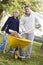 Son helping father to collect leaves