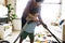 Son helping his mother clean the room