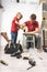 Son helps father repair old furniture in the house.