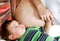 Son listening to unborn baby in his mother\'s tummy