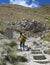 Son and mother descend a steep mountain path during the hike