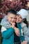 son with mother portrait blooming tree on background