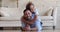 Son piggyback father lying together on floor looking at camera