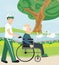 Son pushing senior father on wheelchair outdoors for a walk