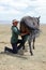Song Kul lake, Kyrgystan, August 15 2018: Young Kyrgyz milks a horse mare