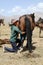 Song Kul lake, Kyrgystan, August 15 2018: Young Kyrgyz milks a horse mare