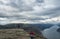 Songesand, Norway, September 9, 2019: Group of tourist people admiring beautiful view and posing at Preikestolen massive
