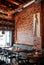 Songkhla - Thailand - Vibrant cool industrial loft restaurant interior style with leather couch, wood chairs and
