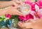 Songkran festival sign of Thailand : Hand of young people pour water, flowers on older. Thais celebrate Songkran in new year water