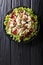 Sonoma salad with chicken breast, celery, pecans and grapes seasoned with spicy sauce close-up on a plate. Vertical top view