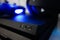 Sony black Playstation 4 Pro game console and blue wireless controller