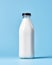 Soothing Simplicity: Vintage Milk Bottle on Tranquil Blue Backdrop