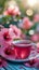 Soothing tea moment Cup of hot hibiscus tea with floral ambiance