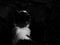 Sophisticated Black and White Artistic Image of the back view of a cat looking at a wall.