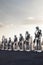 Sophisticated robots stand are arranged in a row, backdrop of a glittering city. Generative AI