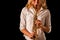 Soprano saxophone in the hands of a girl on a black background