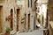 SORANO, ITALY - JUNE 8, 2019: The narrow streets of Sorano, an ancient hill town hanging from a tuff stone over the Lente River.