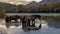 Sorrel liver chestnut wild horse stallion with his small band of mares at sunset in the Salt River near Mesa Arizona USA