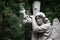 The Sorrowful Angel. Marble mourning angel with a cross, space f