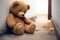 Sorrowful scene Teddy bear sits against house wall, childs loneliness