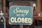 Sorry we are closed sign hanging outside a restaurant, store, office or other