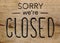 Sorry we`re closed, information sign on wooden signboard
