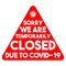 Sorry we are temporarily closed due to Covid-19 with bacteria. Vector inscription in the red triangle on the closed office door,