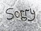 Sorry text written on snowy surface. Sorry note. Apologize concept