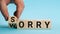 Sorry to worry. Hand turns a cube and changes the word worry to sorry. Business concept, copy space