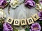 Sorry word wooden block with artificial roses flowers decor