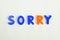 Sorry written in different colored letter blocks on a white background