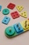 Sorter on neutral background. Multicolored logic sorter close up. Wooden educational logic toy for kid's. Montessori