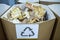 Sorting recyclables. The sorted wooden rubbish, is placed in a container with the appropriate marking