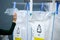 Sorting recyclables. Volunteer eco-activist sort polyethylene Terephthalate PET plastic bottles by color to a containers with