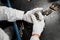 Sorting and selective quality control of weapon cartridges. Hands of the worker in gloves hold cartridges.