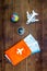 SOS Save the planet and ecology concept with the earth, compass, passport and plane on dark wooden background top view