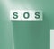 SOS symbol on wooden cubes. Save Our Souls call for help concept