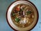 soto sapi or beef soup served on white bowl. soto sapi is Indonesian traditional food, made from rice, beef, bihun, and soup.