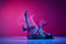 Soul. Young talented artistic woman in bodysuit dancing contemp over gradient pink studio background in neon with mixed