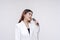 A soulful young woman holding a microphone towards her mouth while facing sideways to the right. Isolated on a white background