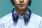 Sound contents. Lower part of face of a young beautiful man wearing blue shirt with a blue headphones closely