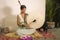 Sound healing and meditation therapy - attractive and elegant Asian Chinese healer woman playing drum at yoga studio as relaxation