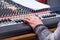 Sound mixing and amplifying equipment in studio. Operator regu