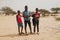 Soungou Roungou, Senegal, Africa, January 19, 2020: horizontal photography of three boys, standing outdoors on a sunny day