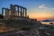 Sounion, Attica / Greece: Colorful sunset at Cape Sounion and the ruins of the temple of Poseidon