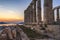 Sounion, Attica / Greece: Colorful sunset at Cape Sounion with the Temple of Poseidon. God of the sea, earthquakes