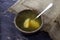 Soup with boiled egg in a clay antique bowl on a black marble background and rough linen cloth