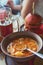 Soup borscht in a deep clay plate, Burger and a glass of drink on the background of the restaurant.