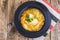 Soup with chicken, pumpkin and noodles on wooden table