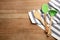 Soup ladle, spatulas and napkin on wooden background, top view